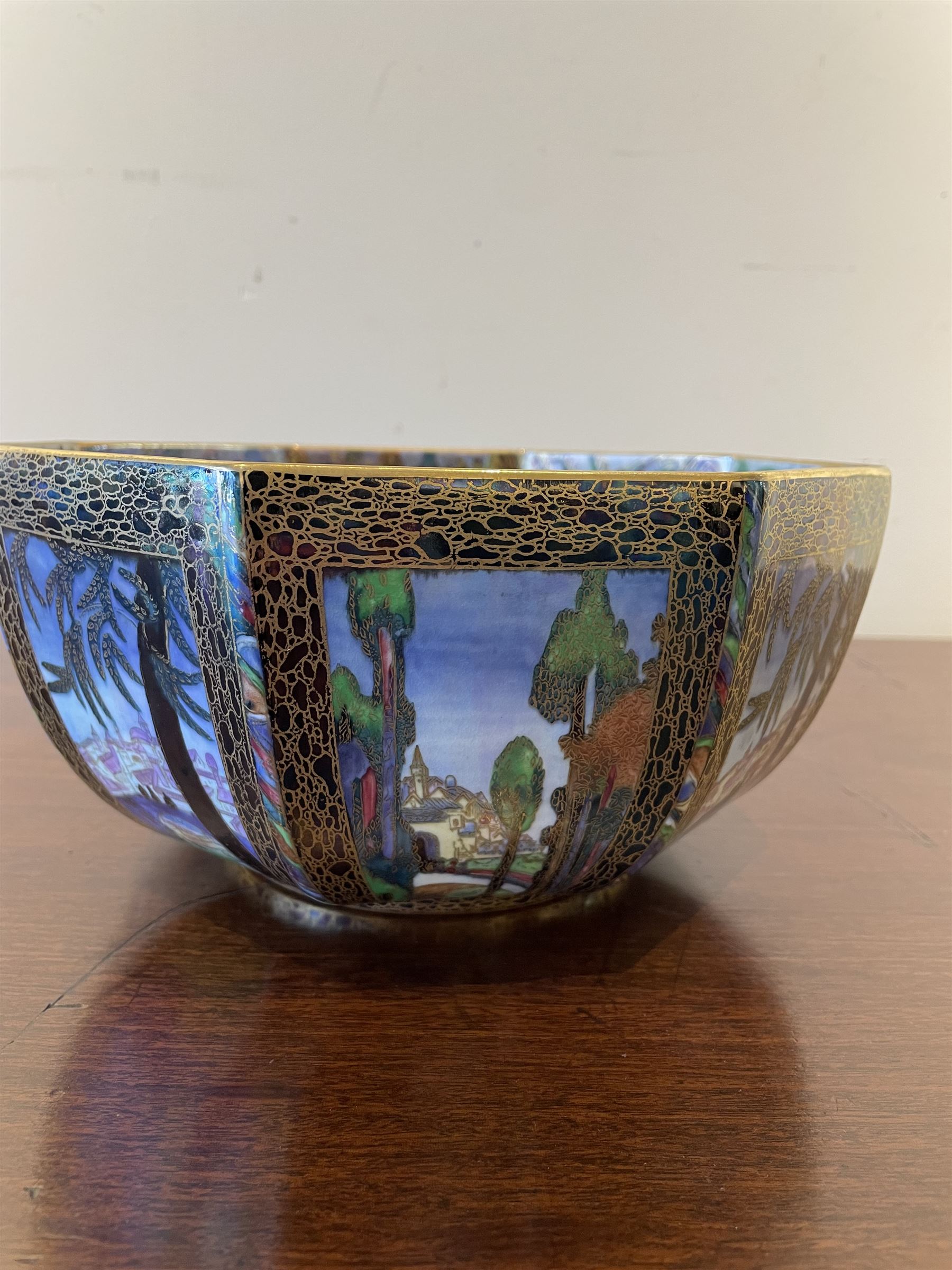 Early 20th century Wedgwood Fairland lustre bowl, circa 1920, of octagonal form, designed by Daisy Makeig-Jones, the exterior decorated in the Castle on the Road pattern, the interior decorated in the Fairy in a Cage pattern, pattern no Z5125, with printed marks beneath, H11cm D22.5cm
