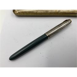 Three parker fountain pens, one example with 14ct gold plated cap and personal engraving, in Parker 51 box, together with a silver Sampson Mordan Everpoint propelling pencil with personal engraving and a silver cased fountain pen with 14ct gold nib and a souvenir bronze Dollfus-Mieg medallion, awarded to John G Sedorski, in fitted case 