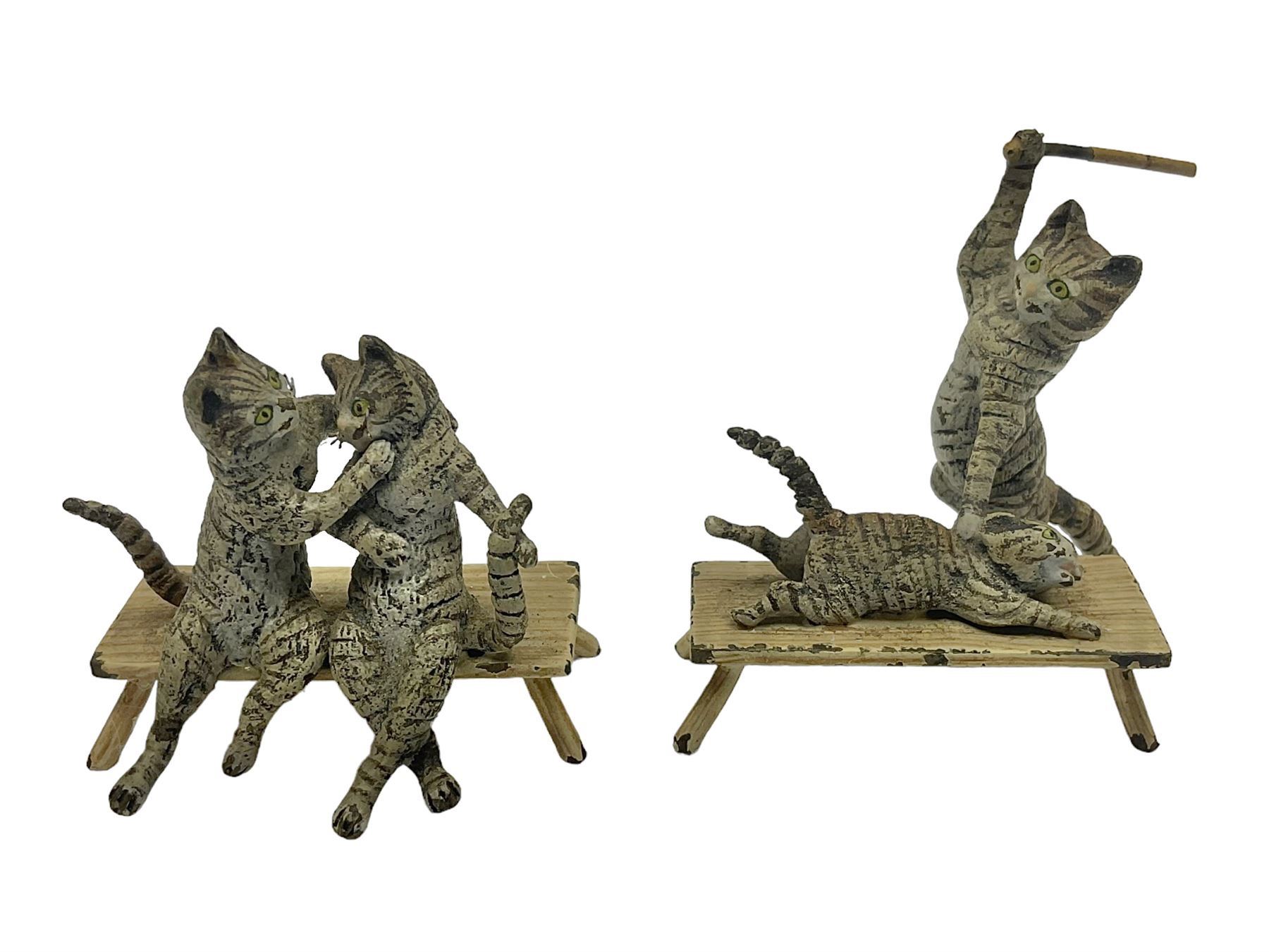 After Bergmann, two cold painted bronze figures, the first modelled as two cats on a bench hugging, the second a cat caning a kitten