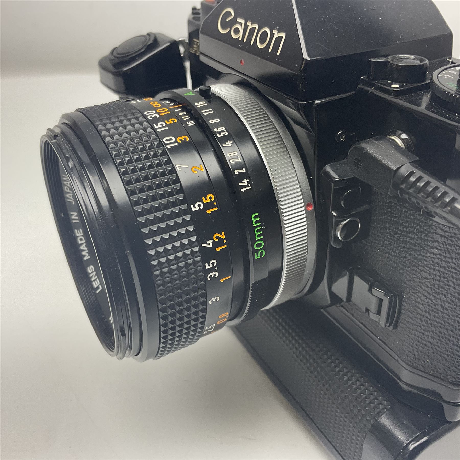 Canon A-1 camera body, serial no. 341014, with 'Canon FD 50mm 1:1.4 S.S.C.' lens, serial no. 12077119 and motor drive MA
