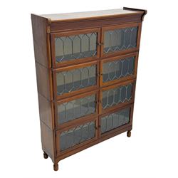 Early 20th century Globe Wernicke design stacking walnut bookcase, fitted with four sections each with two leaded glass doors, raised on turned feet