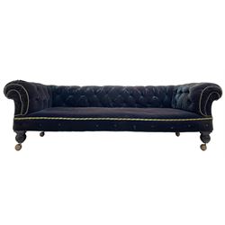 Late 19th century Chesterfield three seat sofa, upholstered in buttoned blue velvet with sprung seat, raised on turned bun feet with castors