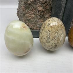 Fossilised coral egg, together with three onyx eggs, mineral bookends and a carved stone