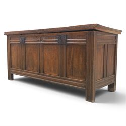 Large 17th century oak coffer, plank top with moulded edge, four panel front with channel moulded uprights, retaining original wrought iron strap hinges and central lock plate, panelled ends, raised on stile supports