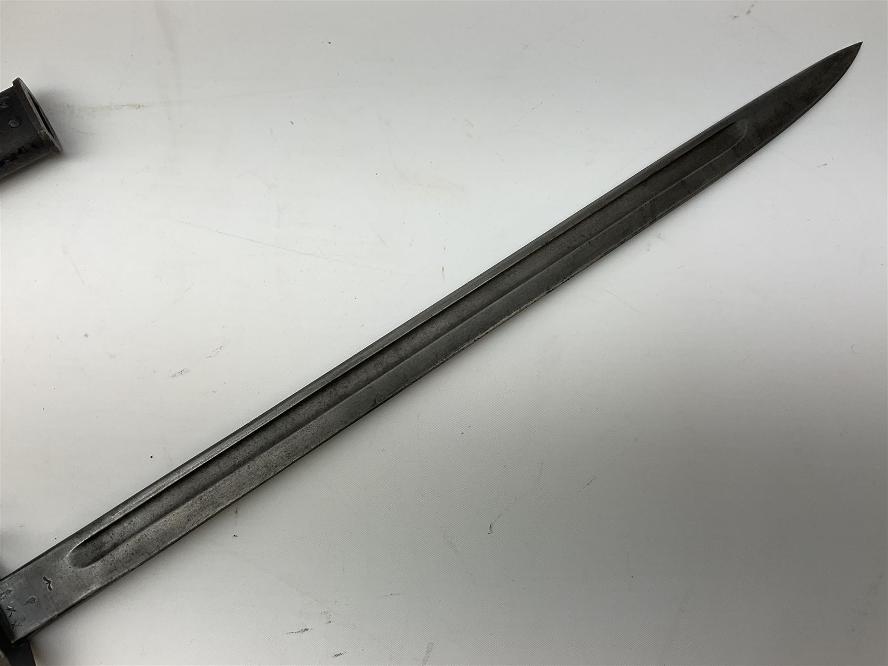 British Enfield 1907 model SMLE bayonet, with 43cm fullered steel blade and metal mounted leather scabbard L58cm overall; and Schmidt-Rubin Model 1918 bayonet the 30cm steel blade marked Elsener Schwyz No.579722; in steel scabbard with leather frog marked G. Bertolini Sellaio Vira/G.Tic 79 L45cm overall (2)