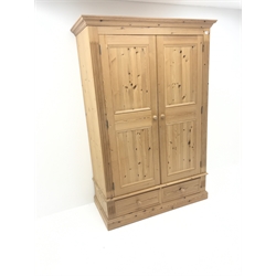  Solid pine wardrobe, projecting cornice, two doors enclosing hanging rail above two drawers, plinth base, W129cm, H195cm, D61cm  