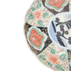 Group of 19th century Japanese Imari porcelain, Meiji period, comprising pair of lobed dishes, decorated stylised reserves and painels in blue and gilt upon a red ground, H6.5cm D21.5cm, a pair of plates of circular lobed form, decorated with a central panel depicting a vase beneath pine branches, and surrounded by panels of flowers and stylised quatrefoil shapes, D21cm, and another similar example painted with a character in underglaze blue to the centre, with character mark beneath, D22cm, each with character marks beneath               