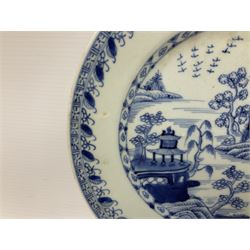 Late 18th/early 19th century Chinese blue and white export plate of circular form, with central panel decorated with river landscape incorporating trees and pagodas, with stylised borders, D23cm