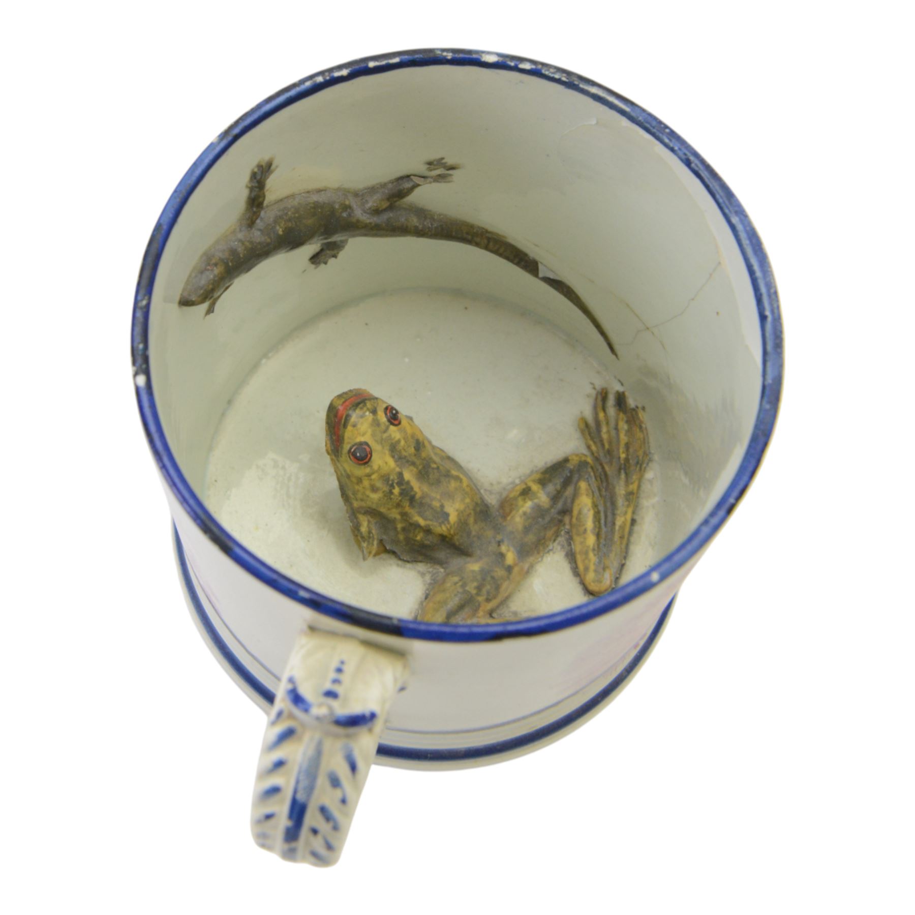 19th century frog and newt cup, decorated with a house in a landscape and cows, featuring a frog and newt inside the cup, together with three other frog cups 