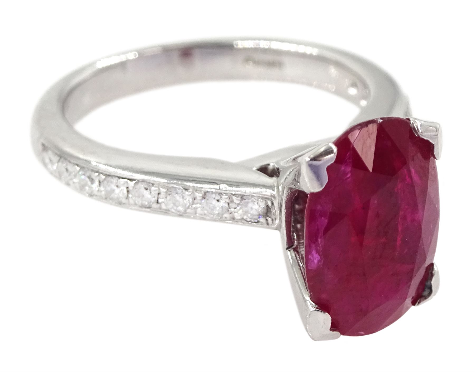 18ct white gold ruby and diamond ring, single oval cut ruby of approx 2.75 carat, with channel set diamond shoulders, hallmarked