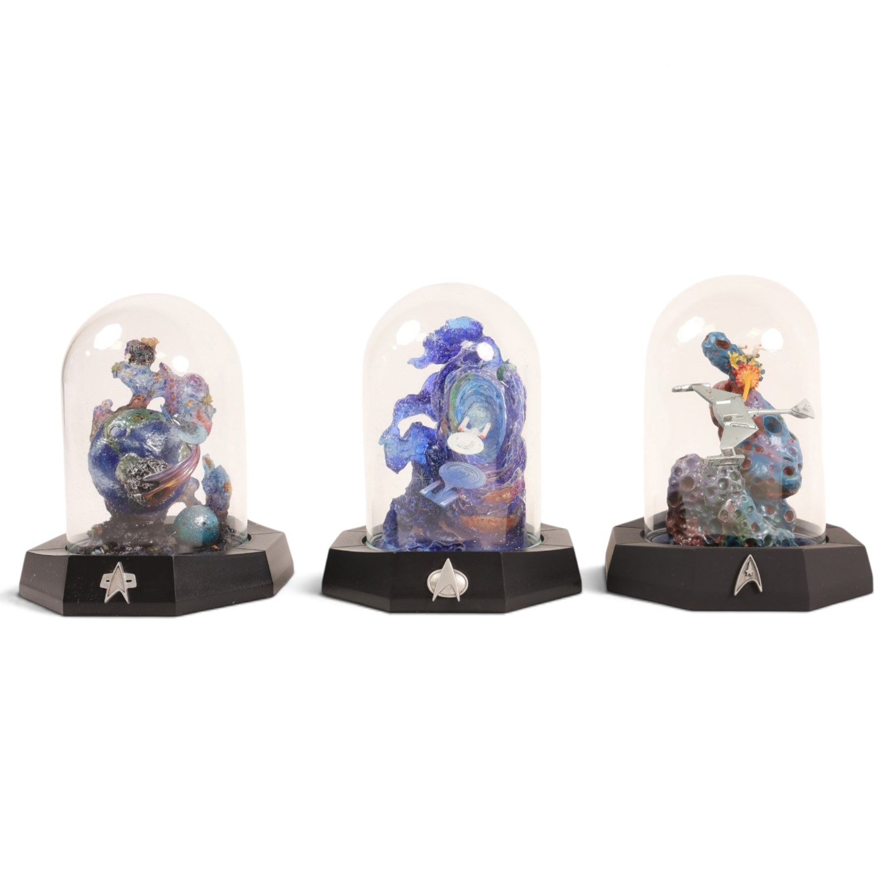 Franklin Mint limited edition Star Trek collectables, comprising seven miniature dioramas under display domes, The USS Enterprise Bold New Millennium large collectors plate, Crystal Edition Galaxy collectors plate and a talking series collectors plate