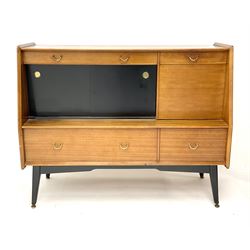 1950s G-Plan retro highboard unit, single long drawer above glazed sliding doors enclosing shaped glazed shelve, alongside a fall front door, above one short and one long drawer, raised on outsplayed tapering supports 