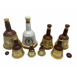 Seven Bell's Whiskey Wade ceramic bell decanters, of various sizes, together with a commemorative decanter for 'the 60th Birthday of her Majesty Queen Elizabeth II', all have been opened.