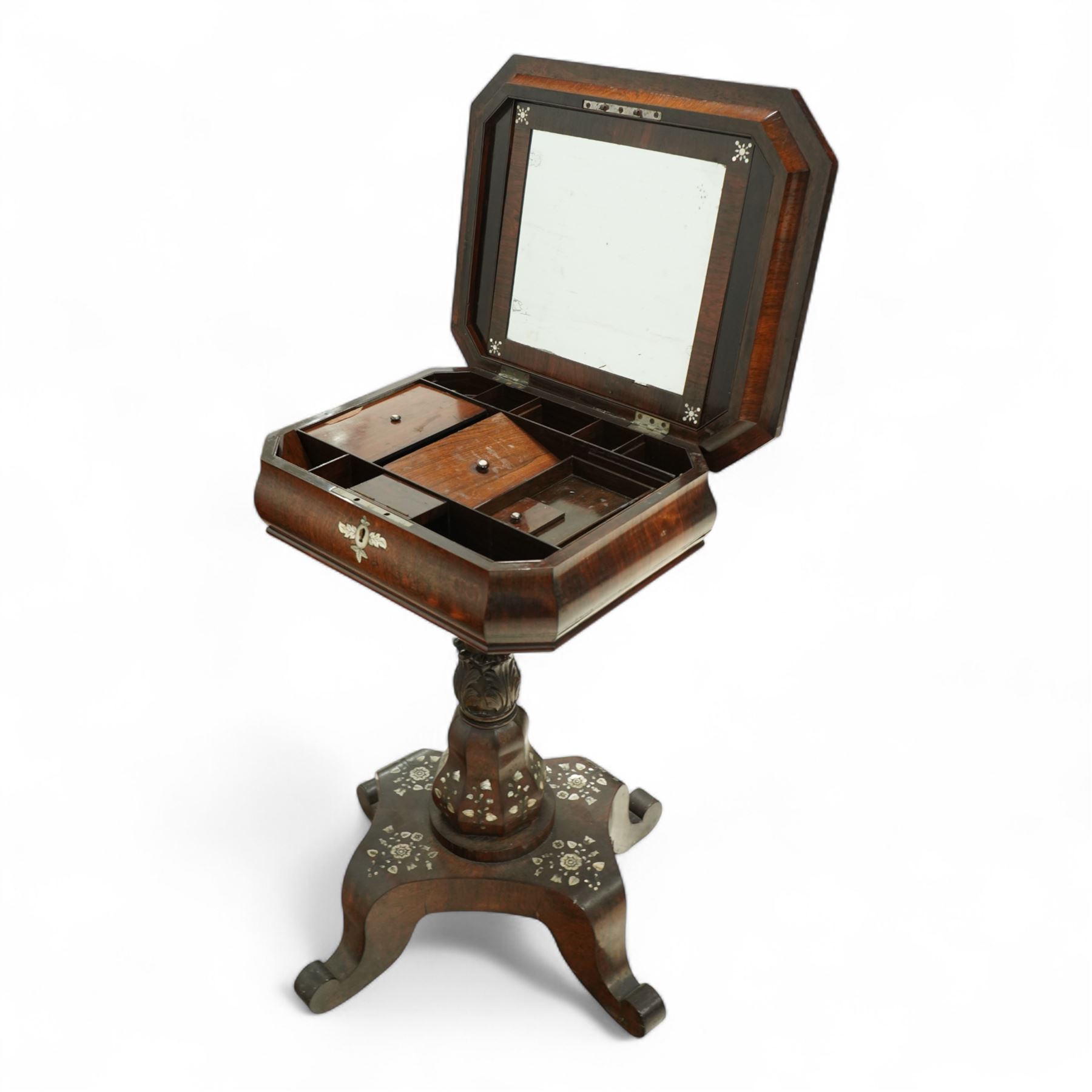 Victorian Mother-of-pearl inlaid rosewood work table, octagonal top inlaid with silvered brass and mother-of-pearl trailing branches of acorn, leaf, and flowering bud decoration, bombe shaped apron with mother-of-pearl leaf inlaid escutcheon, hinged lid with folding mirror, and interior with six lidded compartments and hinged pin cushion above acanthus carved and inlaid pedestal on quattro form base with scroll legs