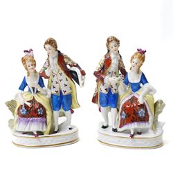 Collection of German and continental porcelain figures, including a figure of Juno with peacock, two figures feeding birds on benches, cherub candlesticks, and others