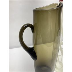 Two Whitefriars glass jugs, together with a Swedish Pukeberg art glass vase and three art glass bowls, including large pink example, some signed to base, tallest H30.5cm