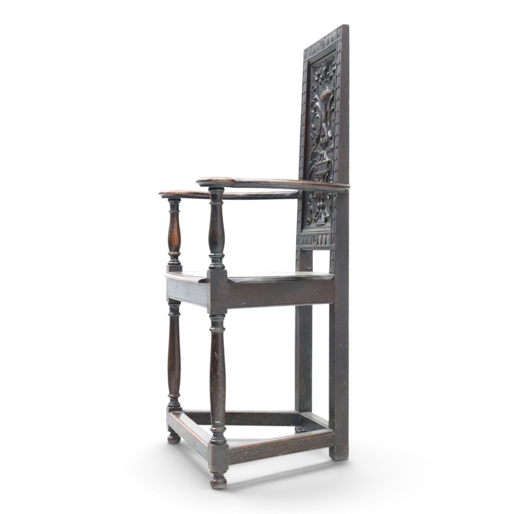 17th design century carved oak hall chair, carved back with urn and foliate details, shaped seat and arms, raised on turned supports united by stretchers