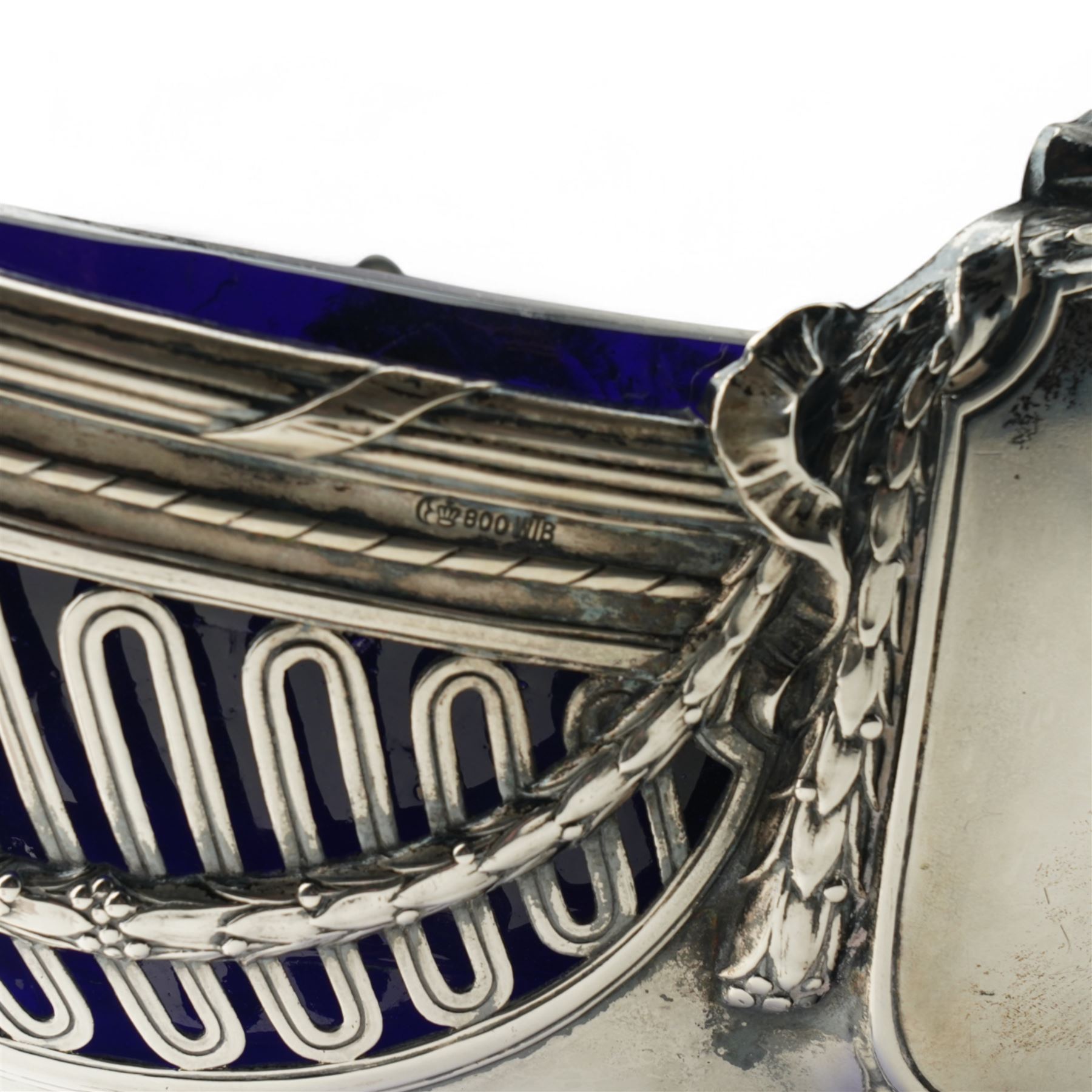 German standard 800 silver oval centrepiece with pierced sides, trailing harebells and swing handle, blue glass liner on splay feet L29cm Maker Wilhelm Binder