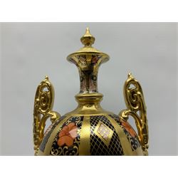 Mid 20th century Royal Crown Derby Old Imari 1128 pattern urn,  circa 1964-1975, of slender ovoid form with gilt scroll handles and fixed cover, upon a pedestal base with canted corners, with printed mark beneath, H30cm