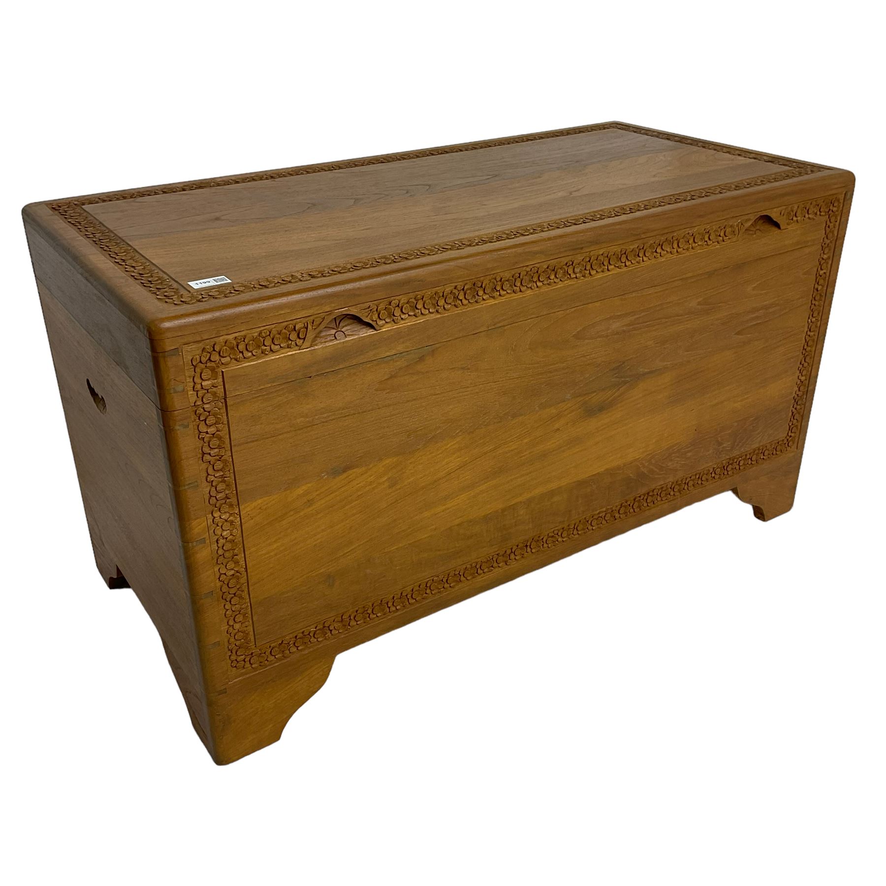 Mid-to-late 20th century Singapore camphor wood blanket chest, the hinged lid and front decorated with flower head carved bands