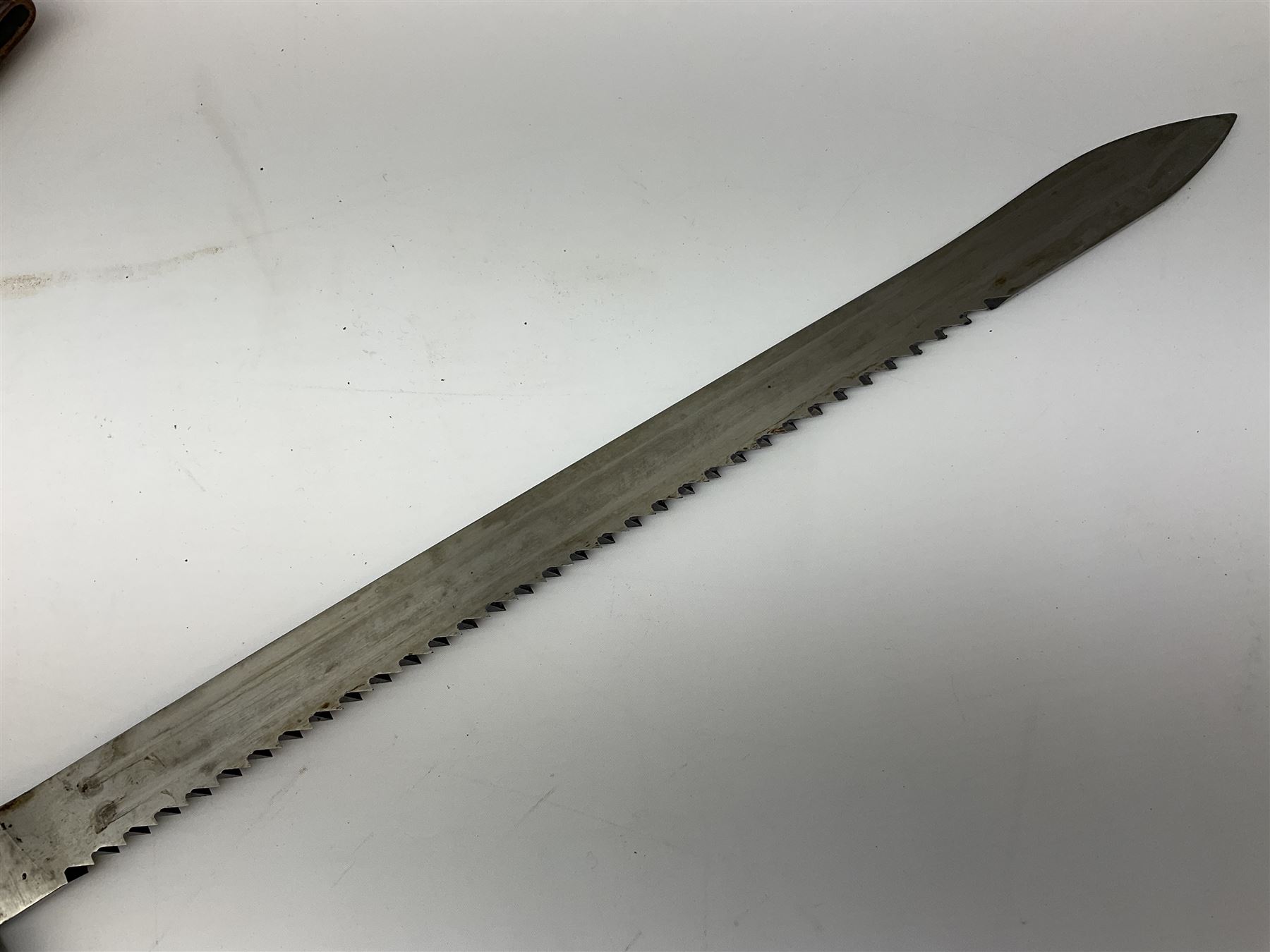 Swiss Schmidt-Rubin M1914 pioneer bayonet, with 48cm steel saw-back blade, the ricasso stamped, ''Waffenfabrik, Neuhausen'', the crosspiece stamped Swiss cross, steel scabbard, leather frog L64cm overall