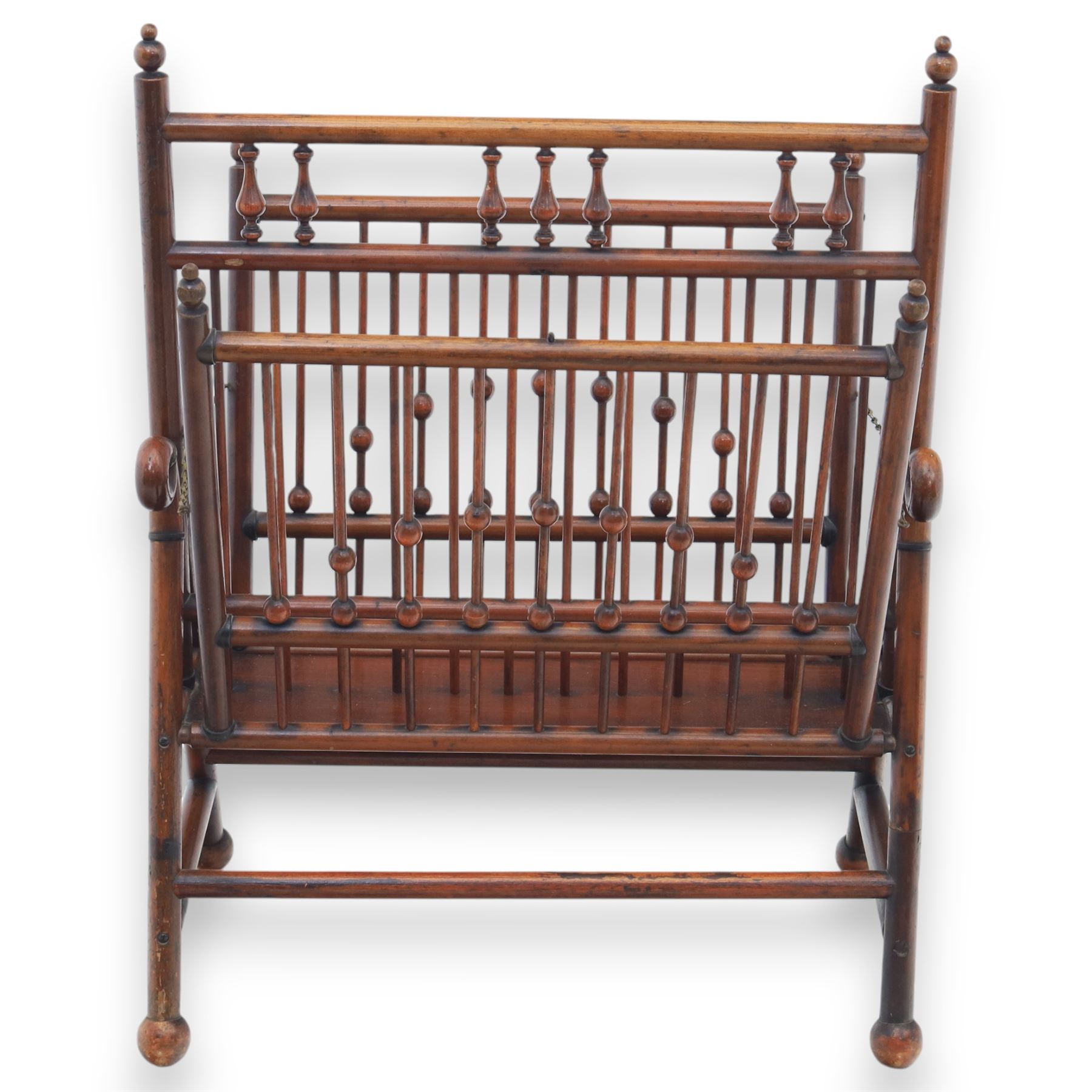 Arts and Crafts mahogany magazine stand, in the manner of Christopher Dresser, folding magazine stand, rectangular divided slatted compartments with turned spindle galleries and ball finials, the sides forming an X-frame action, raised on turned supports united by stretchers