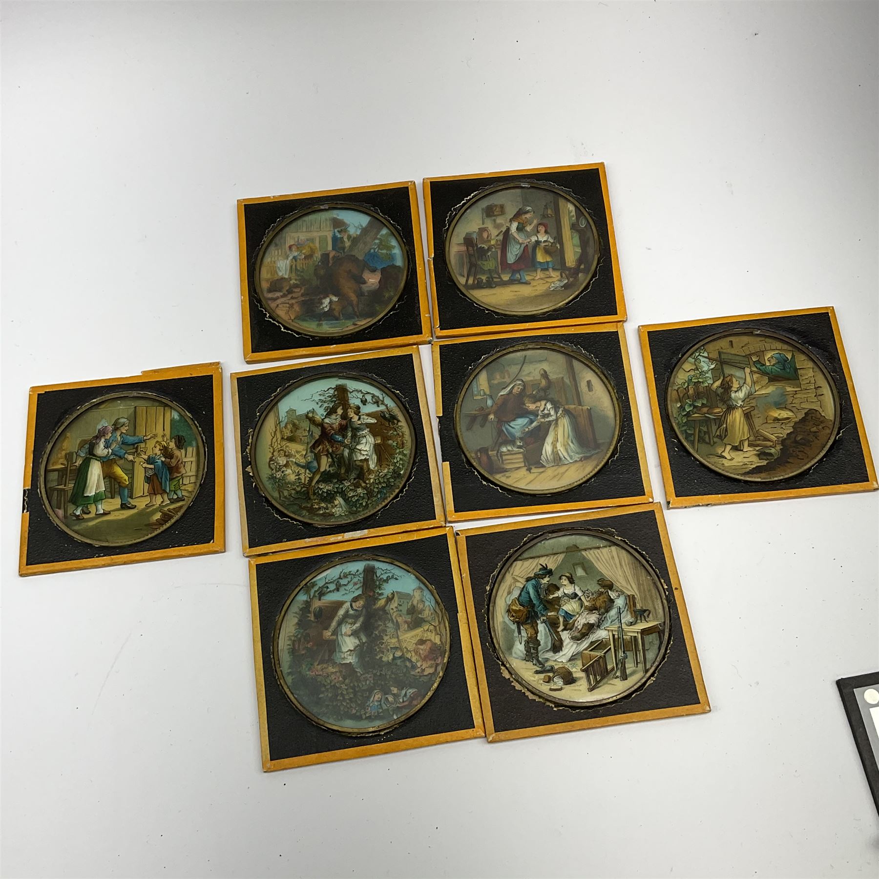 Set of twelve late 19th century magic lantern glass slides entitled 'A Negro's Life', together with forty-two further assorted late 19th/early 20th century magic lantern slides including Union Castle Line to South-East Africa by H.L. Toms London etc, housed in a wooden baize-lined box