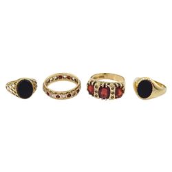 Four 9ct gold stone set rings including two black onyx signet rings, garnet and paste stone and a full eternity ring, all hallmarked