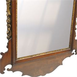 19th century Chippendale design mahogany fret mirror, broken swan neck pediment of foliate design with century bouquet in gilt finish, the rectangular bevelled plate flanked by trailing bellflower motifs, over a shaped terminal