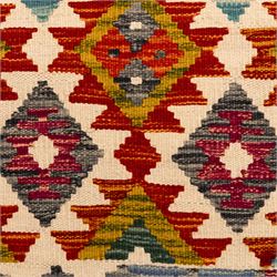Afghan Chobi flatweave kilim runner, with a repeating stepped diamond medallion design in ivory, green, rust, teal, purple, indigo, and framed by chevron and geometric borders