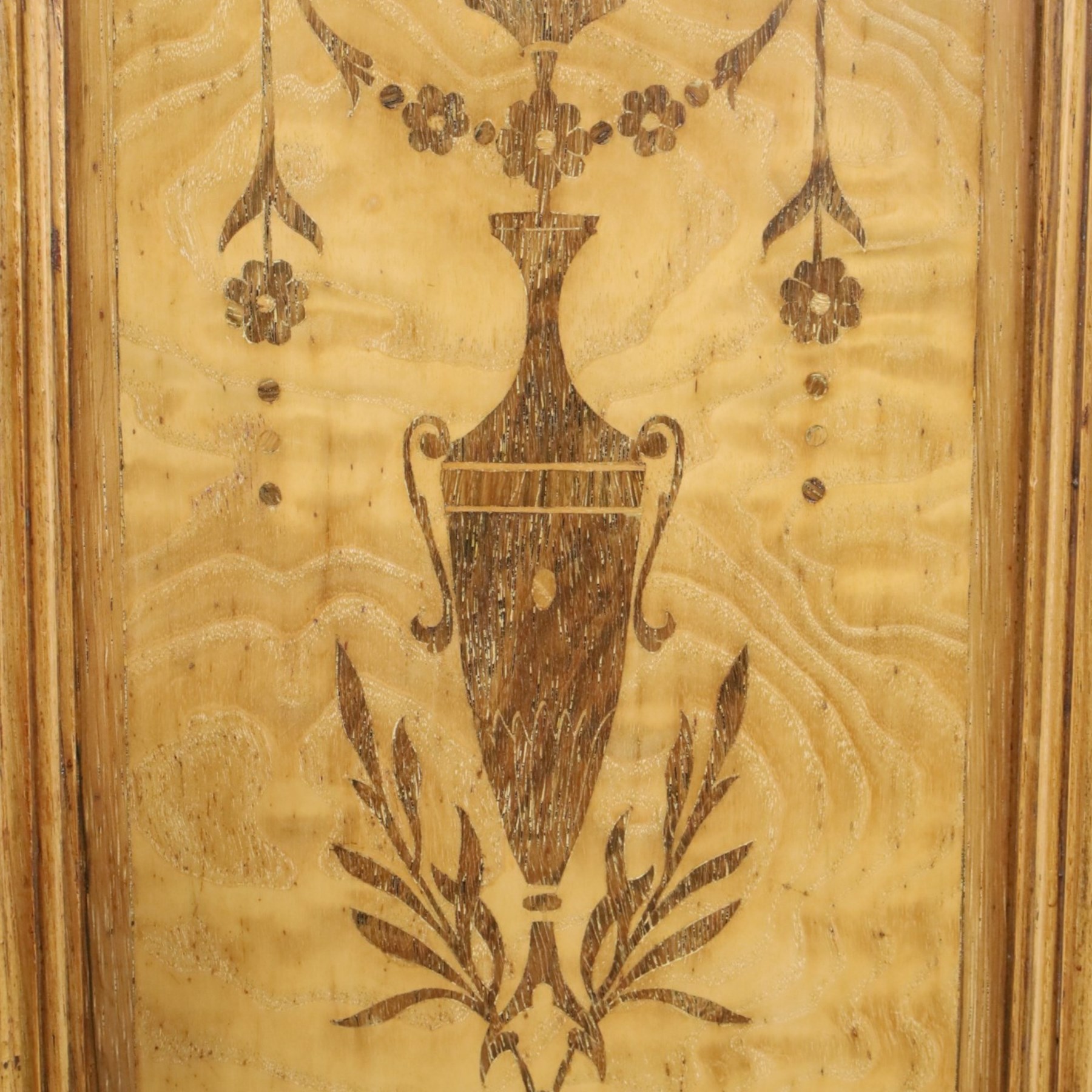 Edwardian Neoclassical figured ash and inlaid double combination wardrobe, the left section with mirrored door enclosing a hanging rail, the right section with cupboard door above four graduated drawers with glass knobs, raised on castors