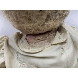 Two early 20th century straw filled jointed teddy bears, first example wearing a tweed jacket bearing Geoffrey Saville label, with leather padded paws and ears, horizontally stitched nose and humpback; second example with applied eyes, vertically stitched nose and faux leather paw pads, both with growler mechanisms, tallest H74cm 