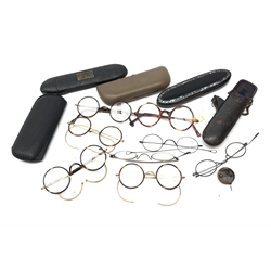  Collection of 19th/ early 20th century spectacles including gold plated, tortoiseshell and white metal framed examples & retractable spectacle holder, with a papier mache inlaid case and other cases   
