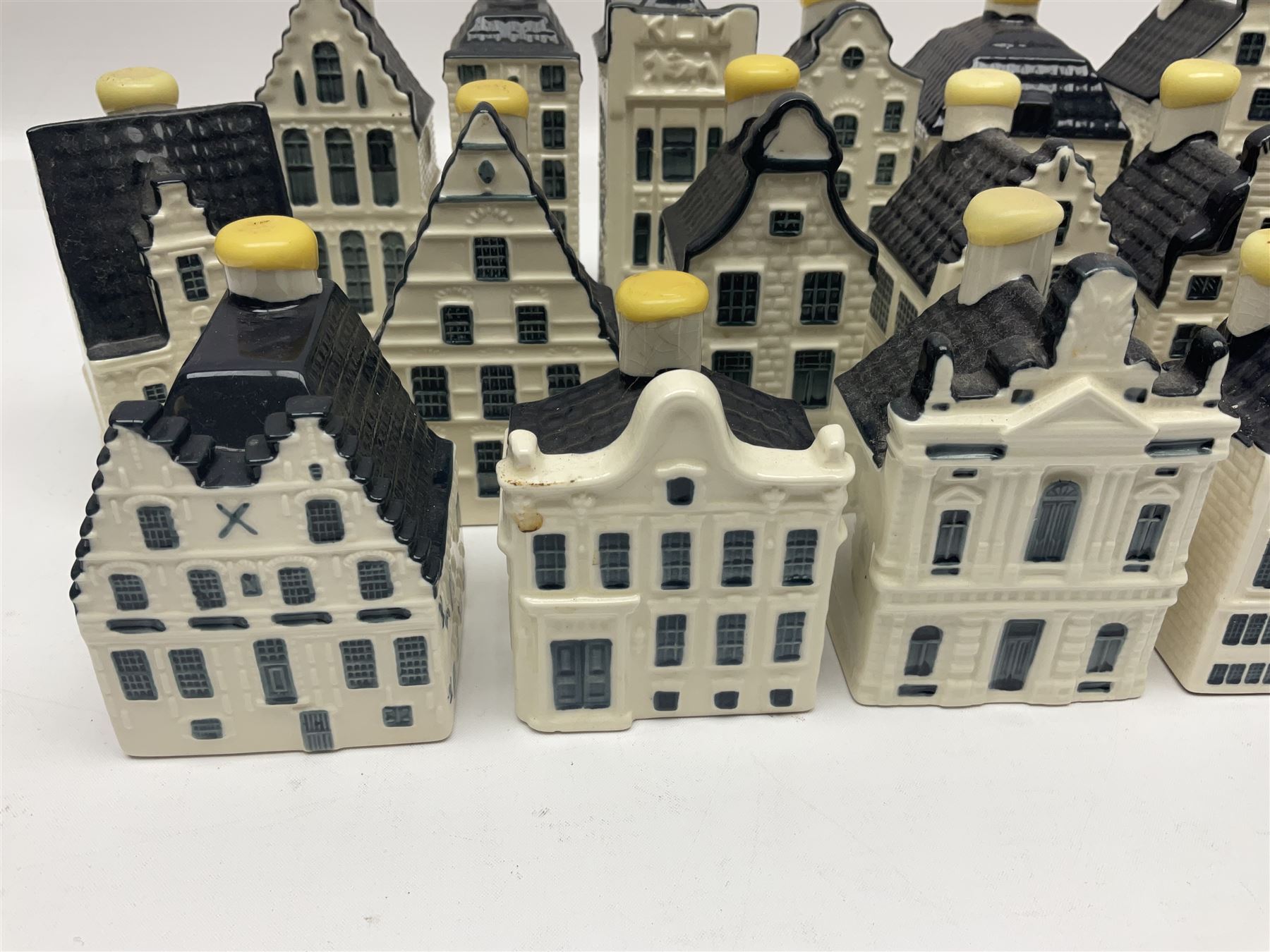 Twenty seven KLM Bols Blue Delft's decanters in the form of Dutch houses, some with contents