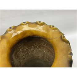 Early 20th century Royal Doulton stoneware vase, decorated with a stylized floral design below a wavy rim, monogrammed B.N, possibly for Bessie Newbery, H28cm, together with an early 20th century glazed jug, heavily carved throughout (2)
