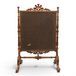 Two Victorian fire screens, comprising mahogany pole screen with glazed floral woolwork panel on turned support and triform base (H 142cm, W 48cm); and a larger carved walnut tapestry fire screen, glazed panel depicting a domestic interior scene, scroll carved cresting, barley twist uprights and turned stretcher base (H 75cm, W 49cm)