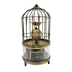 Automation bird cage clock of predominantly brass construction with central rotating orb and two birds with feathered decoration, H19cm