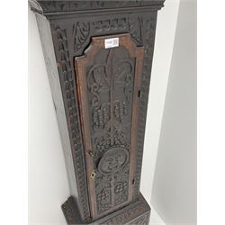 18th century oak longcase clock with later carving, the hood with projecting cornice over square glazed door, trunk door carved with tree of life, foliage carved base, on ogee bracket feet, brass dial with Roman chapter ring and subsidiary seconds and calendar aperture, ornate mask cast spandrels, twin train driven movement striking on bell 