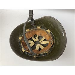 WW2 French M-26 Adrian Pattern Steel Helmet, original olive drab paint finish; flaming grenade badge to the front signifying issue to an Infantry regiment; original leather liner and leather chinstrap; and WW2 Dutch steel helmet with liner and chin strap (2)