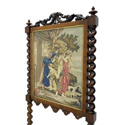 Victorian rosewood fire screen, scrolled foliage carved pediment, rectangular frame with moulded gilt slip enclosing figural needlework tapestry panel, on spiral turned supports with finials united by turned lower stretcher, on out-splayed feet with scroll carved terminals 