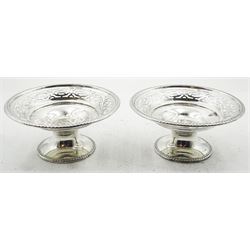 Pair of 1920's silver bonbon dishes, the circular bowls with gadrooned rims and pierced sides, upon spreading circular short pedestal feet with conforming gadrooned edge, hallmarked Walker & Hall, Sheffield 1922, H5cm D10.5cm, approximate weight 3.84 ozt (119.6 grams)