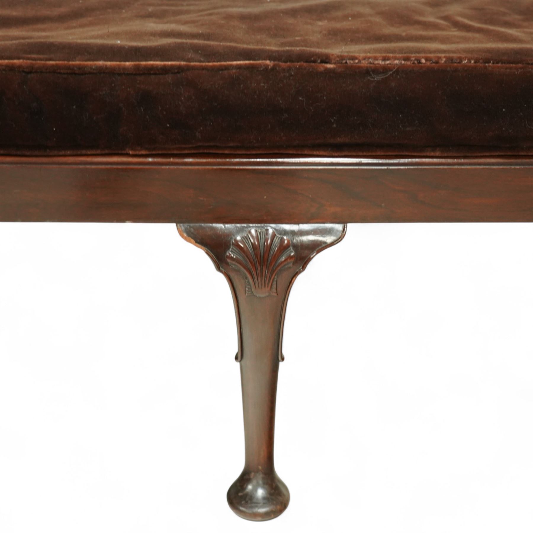 Early 20th century mahogany window seat in the George II style, with rectangular padded seat upholstered in brown velvet, raised on cabriole legs with carved shell knees and pad feet