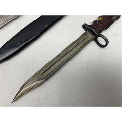 British No 7 MKI knife bayonet with 20cm single edged fullered clipped point blade;  blackened steel, large muzzle ring cross-guard; blackened swivelling pommel marked 'F5H'; red Tufnol composite grips; in blackened steel scabbard L33cm overall; British Pattern 1888 bayonet with scabbard; and German Ersatz bayonet with scabbard (3)