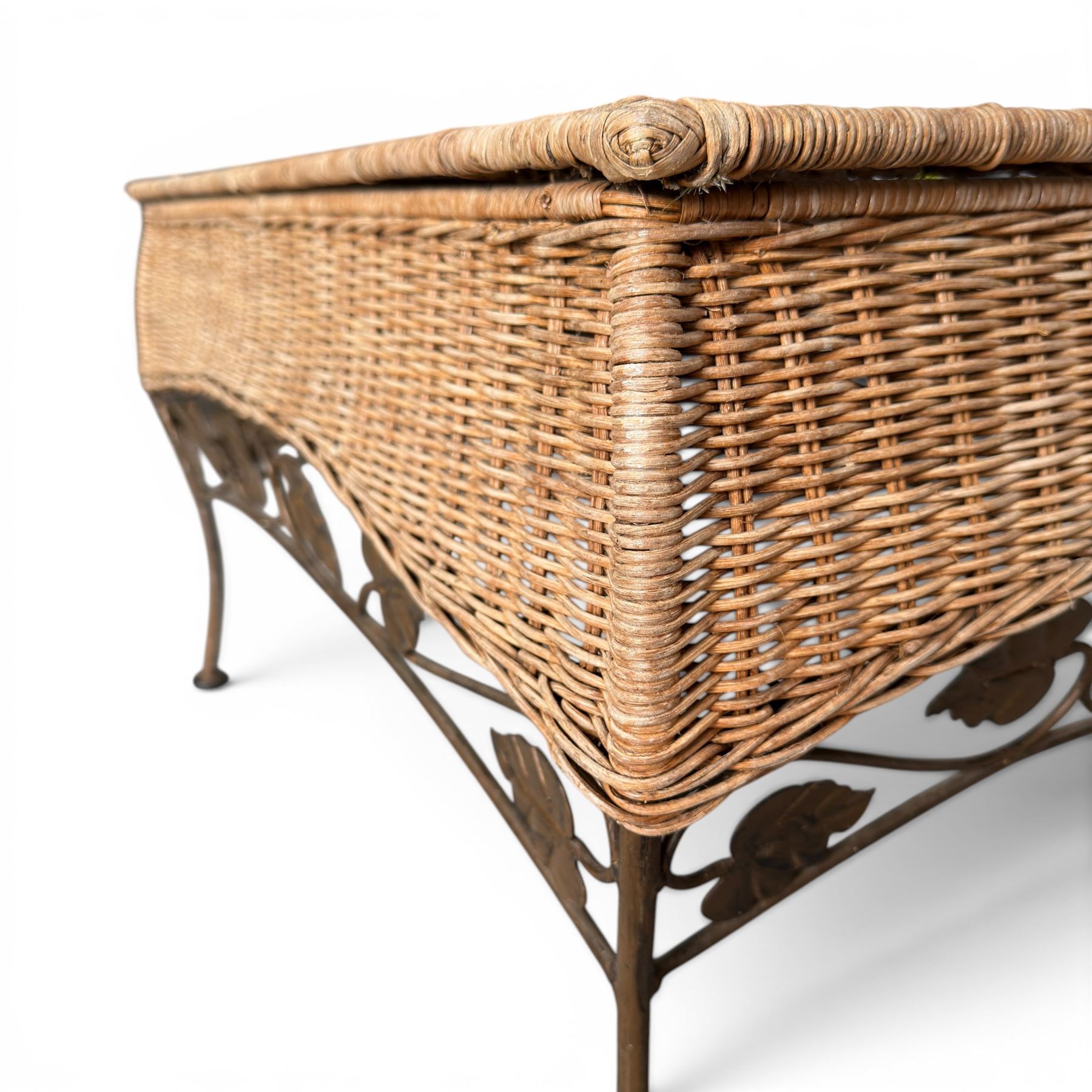 Basket work coffee table featuring scrolling leaf edging on tapered lags