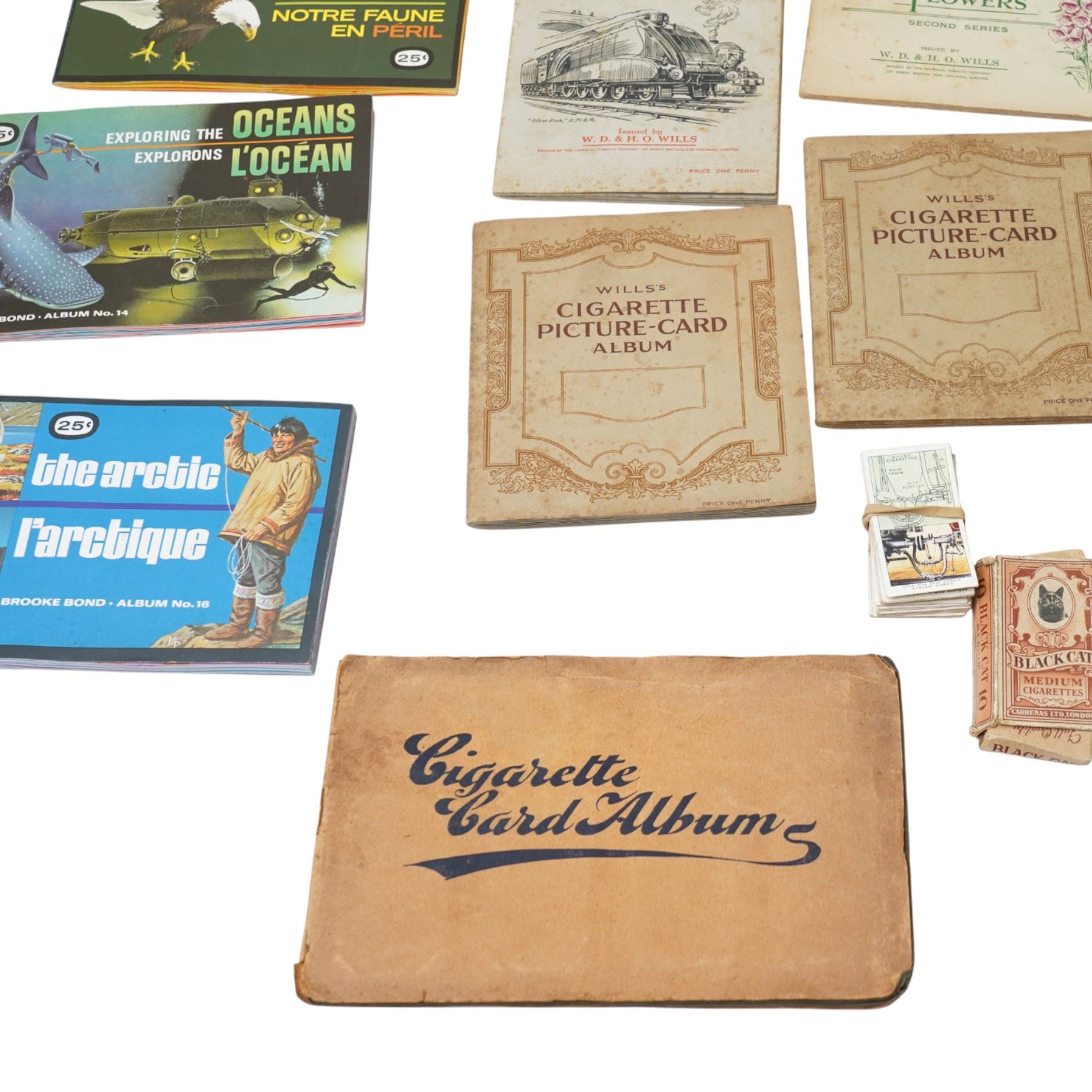 Seven albums of Wills cigarette cards including Wild Flowers, Railway Engines etc., Carreras Birds of the Countryside and five trade card albums