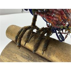 Victorian bead and wire model of a parrot, of polychrome beads, with glass eyes, on a wooden base, H24cm