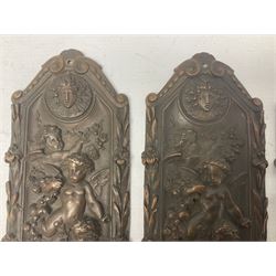 Set of four Victorian Elkington & Co copper door plates, each of shaped rectangular form, cast with putti in flight supporting a rose garland, between two mask roundels, and contained within a foliate border, with lozenge shaped mark verso detailed Elkington 1570, the facias impressed with registered diamond mark dated 8th June 1866, H31cm W10cm