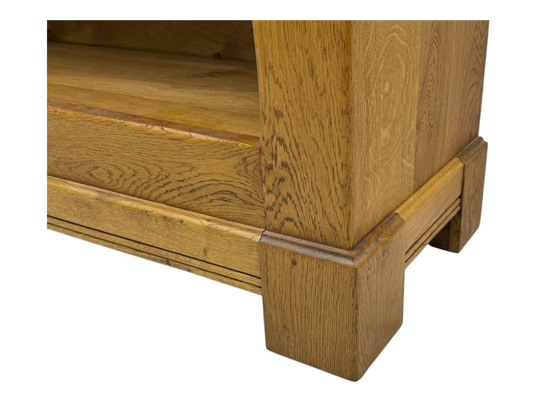 Contemporary French provincial design oak open bookcase, with projecting moulded cornice above a boarded back, fitted with four adjustable shelves, on bracketed plinth base