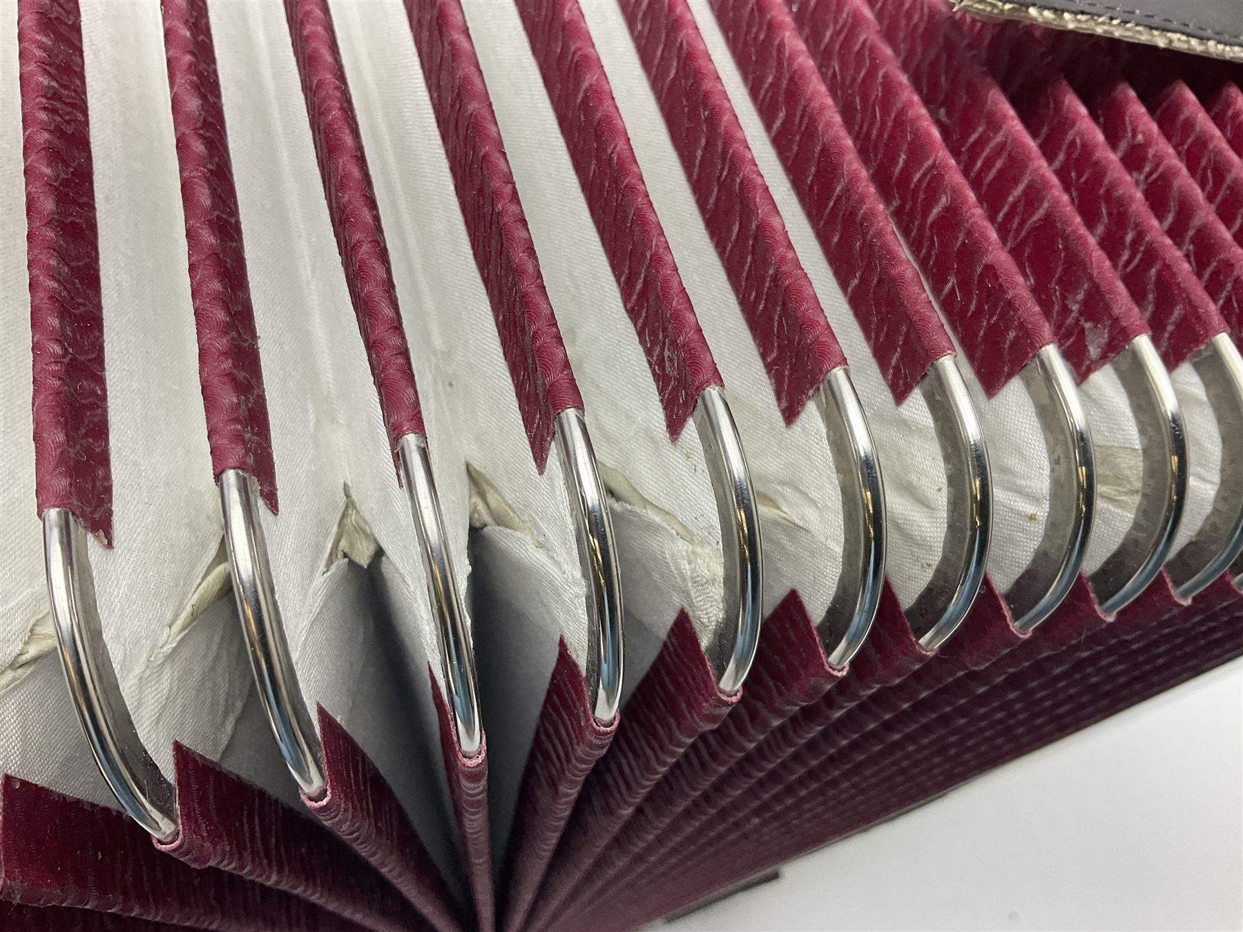 Hsinghai Studio piano accordion with red pearline finish, twenty keys and seventy-two buttons W44cm; in hard carrying case with additional The Music Room soft gig case