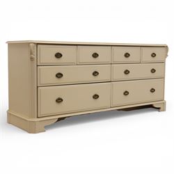 Contemporary French design white painted bedroom suite retailed by Barkers of Northallerton, comprising wide chest fitted with four short and four long drawers with oval brass handles (H 70cm, W 159cm, D 46cm), pair of bedside chests each fitted with three drawers (H 62cm, W 40cm, D 46cm), dressing table fitted with four short drawers and central kneehole with shaped apron (H 79cm, W 131cm, D 46cm) with matching framed wall mounted mirror (H 100cm, W 113cm), and full length standing mirror (H 175cm, W 73cm)